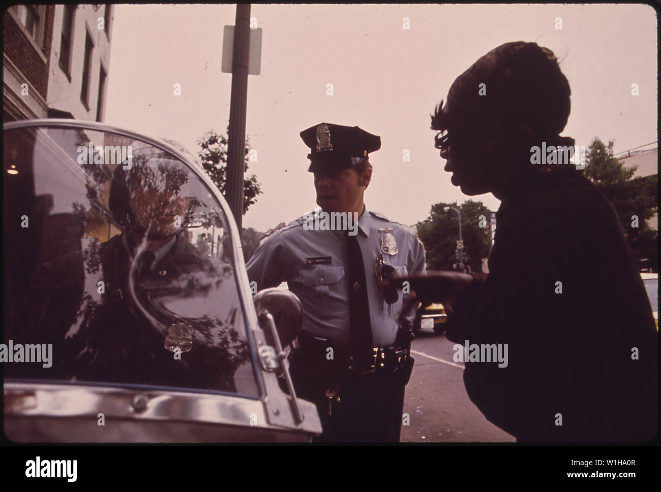 OFFICER CALLS PADDY WAGON FOR DISTURBER OF THE PEACE Stock Photo