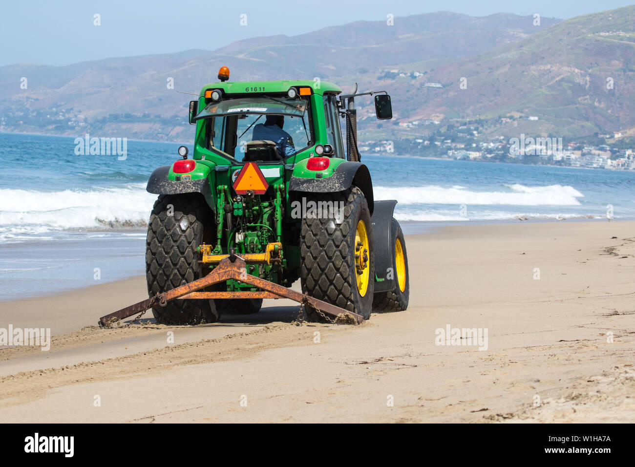 Beach cleaning tractor on Zuma Beach California USA Stock Photo - Alamy