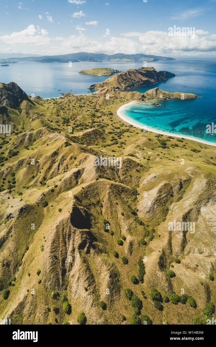 Aerial vertical view of Padar island in Komodo National Park, Indonesia. Drone shot, top view. Mountain view and tropical beach. Stock Photo