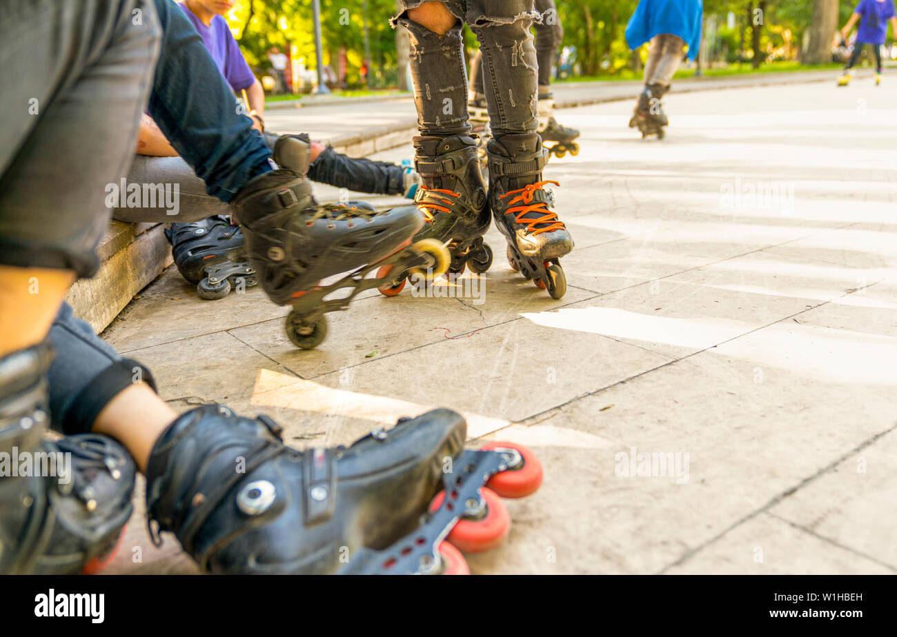 Group of roller skates sitting and resting in outdoor skate park, Close up view of wheels before skating. Selective focus. Stock Photo