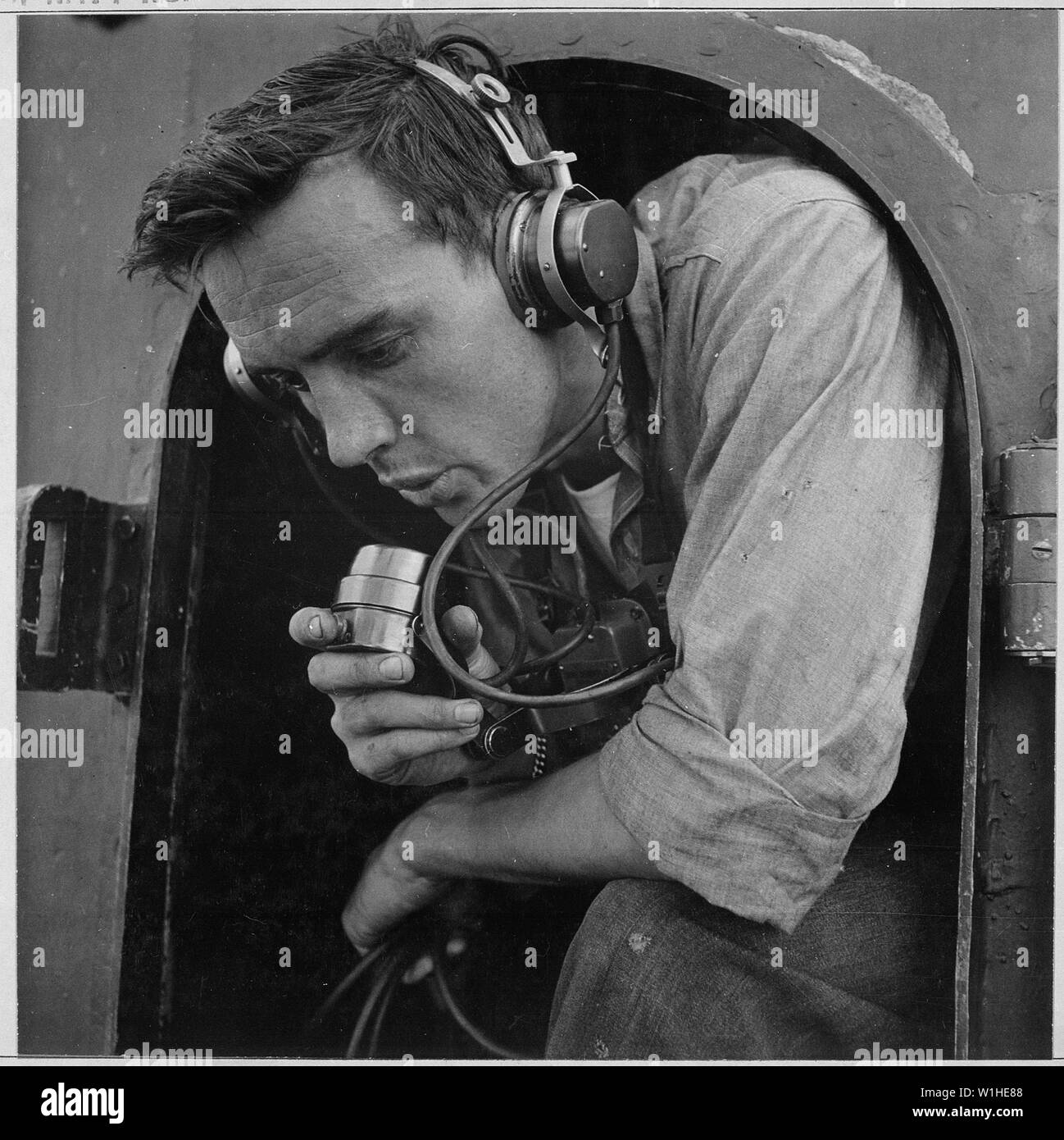 On bridge of U.S. submarine at submarine base New London, Connecticut Relaying commands to quick firing 20mm gun crew.; General notes:  Use War and Conflict Number 939 when ordering a reproduction or requesting information about this image. Stock Photo