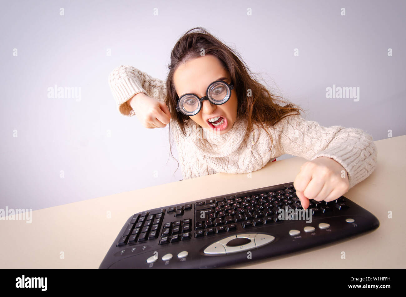 Funny nerd girl working on computer Stock Photo
