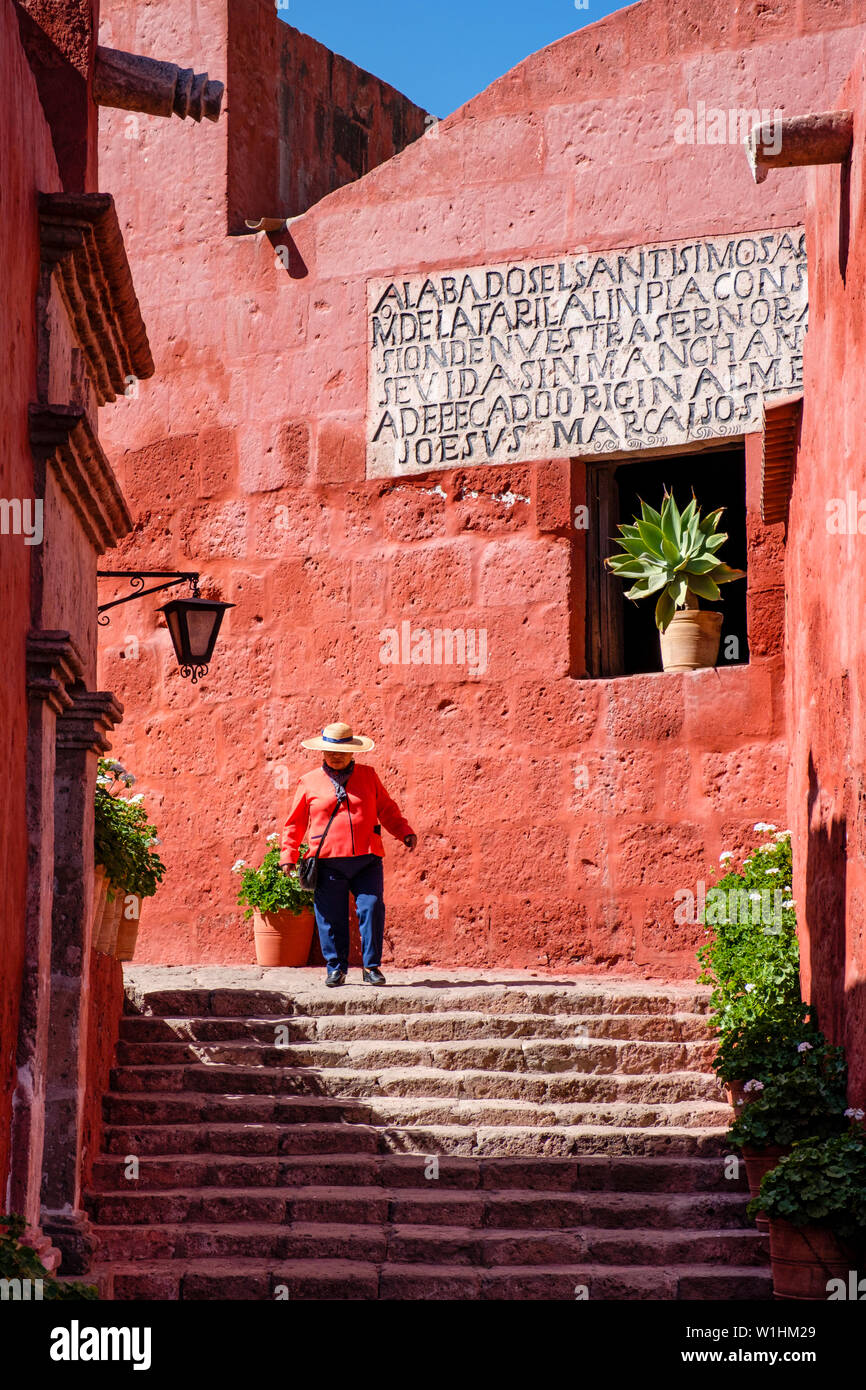 Santa Catalina Monastery female official guide in uniform walking towards Zocodober Square, Arequipa, Peru. Stock Photo
