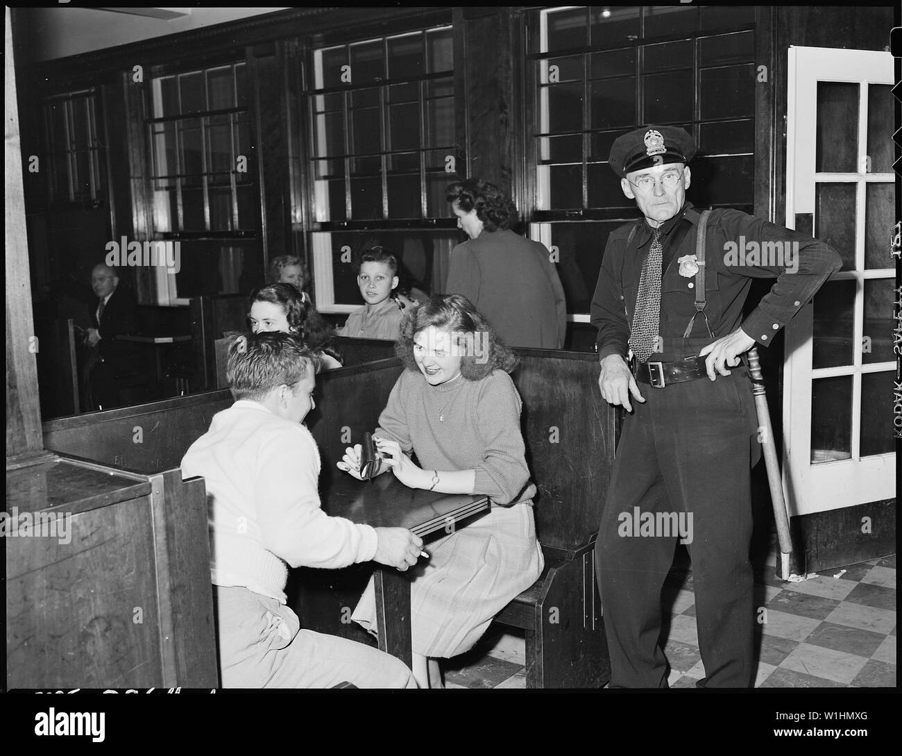 Policeman and couple in soda fountain prior to movie show. Inland Steel ...