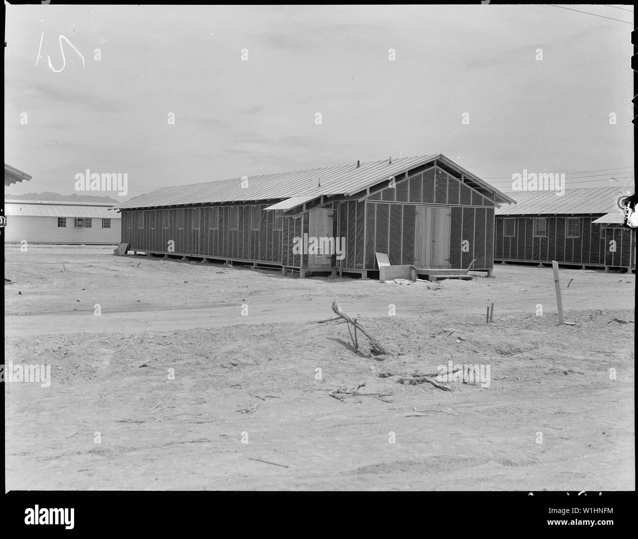 Poston, Arizona. Barrack building typical of those at this War Relocation Authority center for evac . . .; Scope and content:  The full caption for this photograph reads: Poston, Arizona. Barrack building typical of those at this War Relocation Authority center for evacuees of Japanese ancestry. Note the double roof construction for protection against the elements. Stock Photo