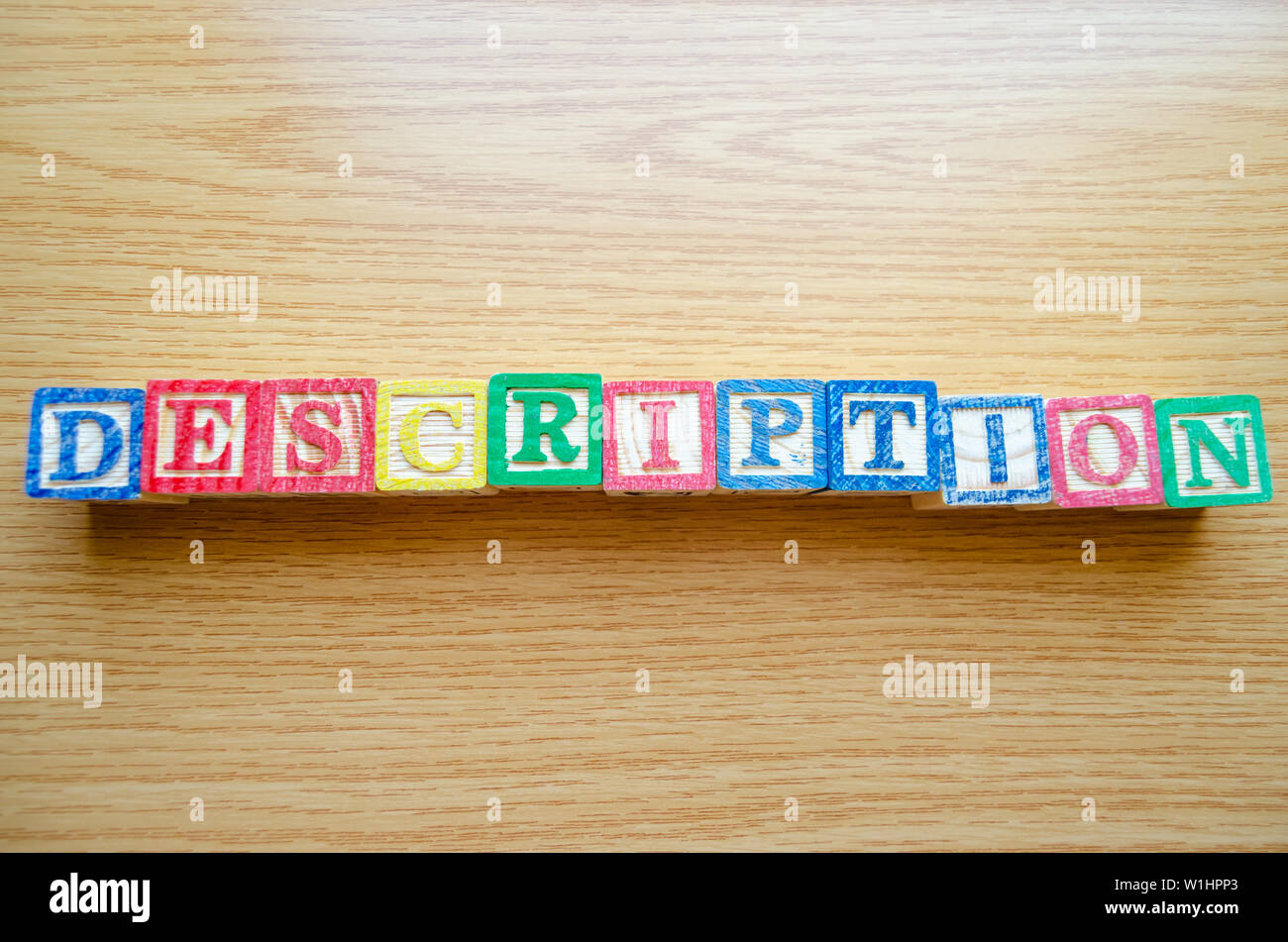 Educational toy cubes with letters organised to display word DESCRIPTION - editing metadata and Search engine optimisation concept Stock Photo