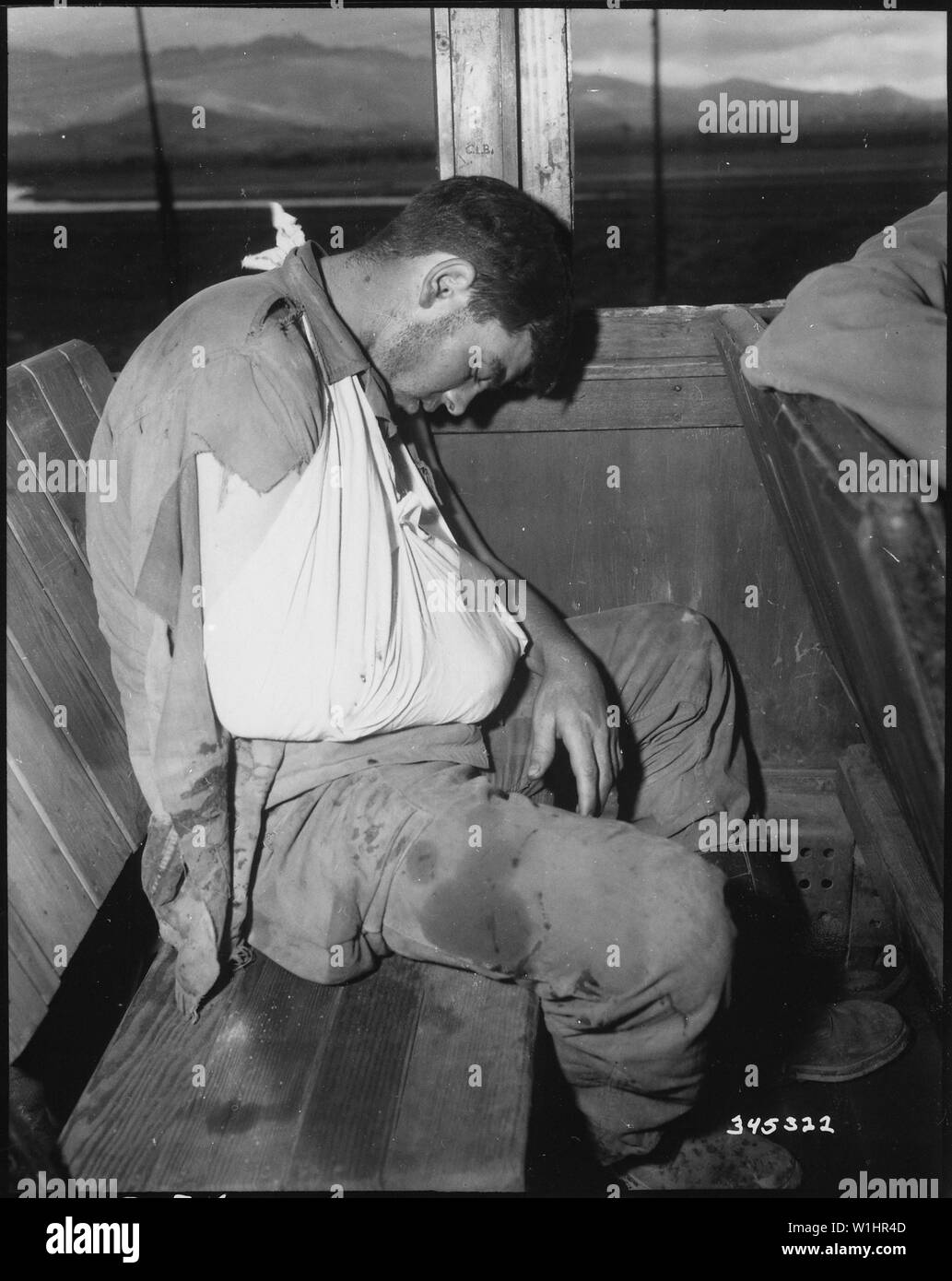 Private First Class, Orvin L. Morris, 27th Regiment, takes a much deserved rest during his evacuation to Pusan, Korea, on a hospital train. He was wounded by enemy mortar fire on front lines.; General notes:  Use War and Conflict Number 1454 when ordering a reproduction or requesting information about this image. Stock Photo