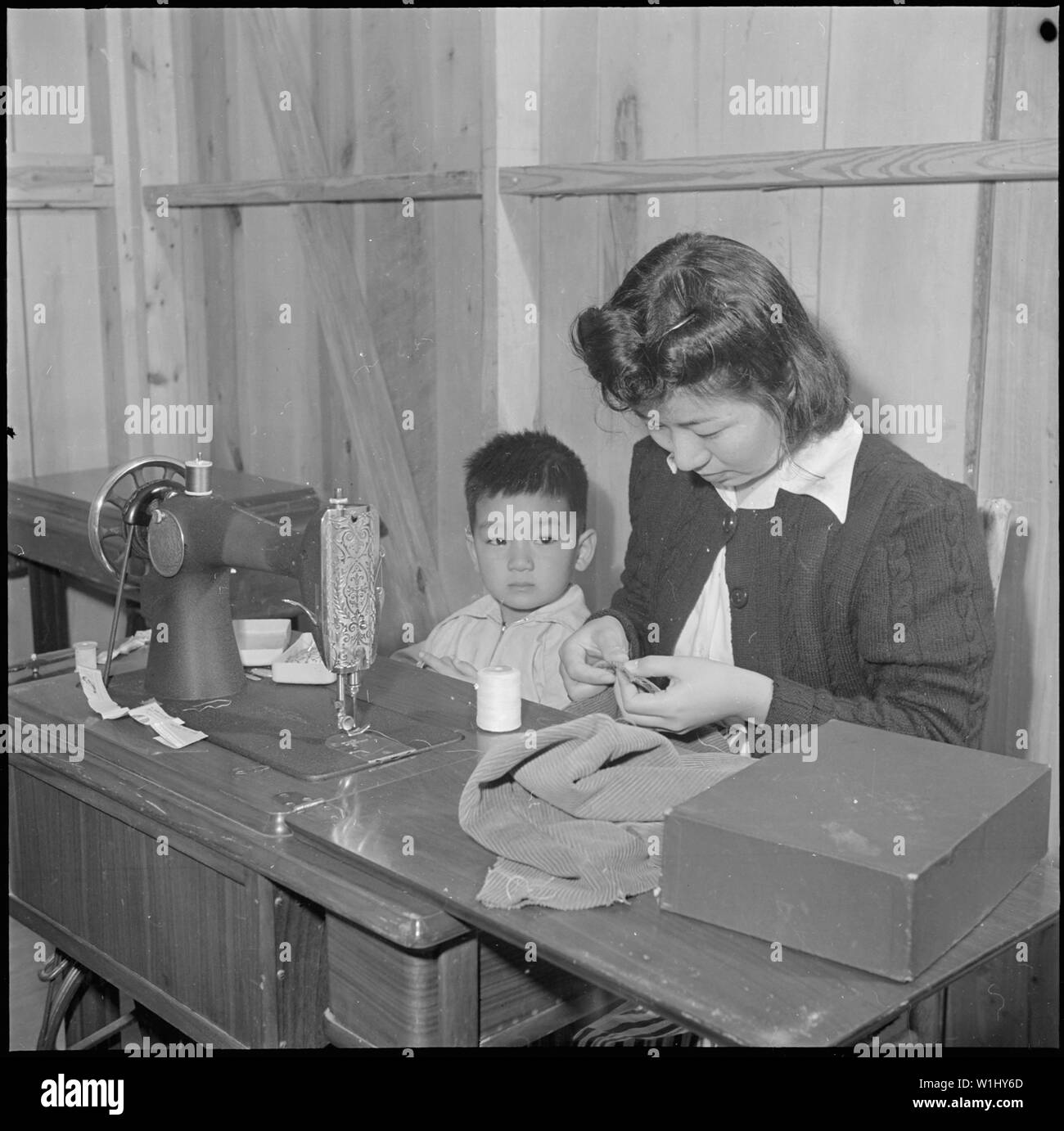 https://c8.alamy.com/comp/W1HY6D/rohwer-relocation-center-mcgehee-arkansas-mrs-shizuka-shibata-attends-an-afternoon-sewing-class-scope-and-content-the-full-caption-for-this-photograph-reads-rohwer-relocation-center-mcgehee-arkansas-mrs-shizuka-shibata-attends-an-afternoon-sewing-class-at-the-rohwer-center-school-and-brings-her-youngest-three-year-old-seemio-along-mrs-shibata-is-one-of-the-many-center-mothers-who-have-enthusiastically-attended-sewing-classes-in-order-to-provide-their-families-with-sufficient-clothing-despite-their-reduced-income-W1HY6D.jpg