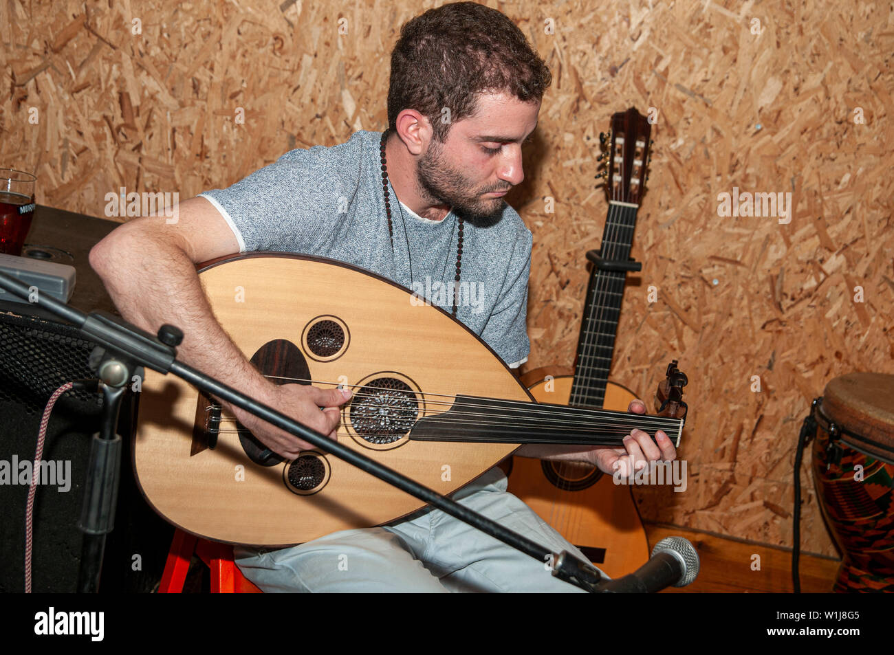 Young Caucasian musician plays an Oud a short-neck lute-type, pear-shaped  stringed instrument Stock Photo - Alamy