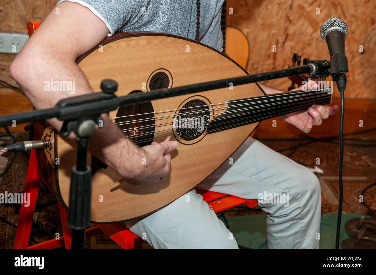 Young Caucasian musician plays an Oud a short-neck lute-type, pear-shaped  stringed instrument Stock Photo - Alamy