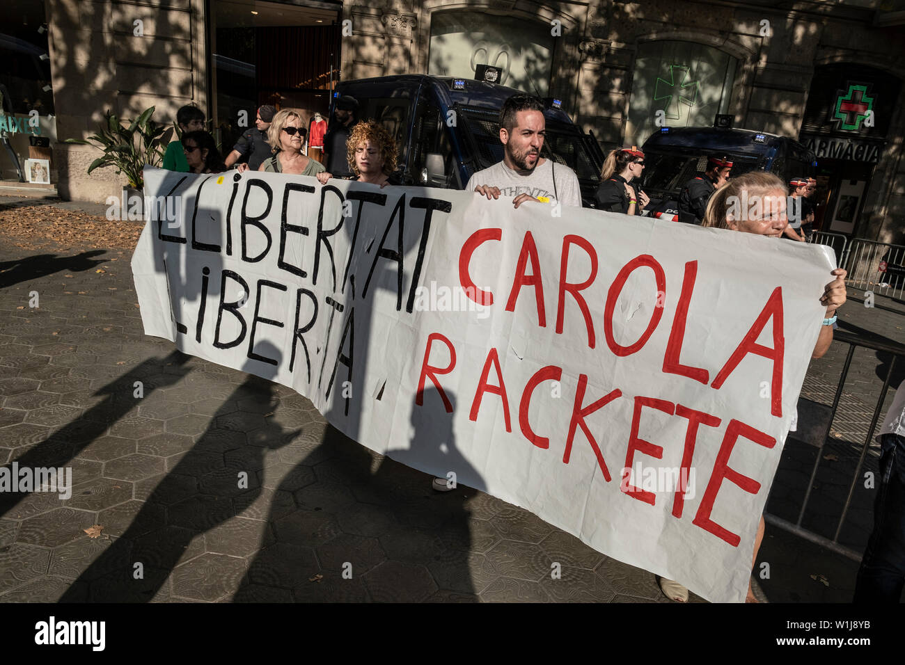 Barcelona, Spain. 02nd July, 2019. Protesters hold a large banner asking for the freedom of Carola Rackete during the demonstration.In correspondence with the rallies in front of the European Parliament in Strasbourg, hundreds of supporters for the independence of Catalonia have gathered in front of the headquarters of the European Commission in Barcelona in support of the three elected Catalan deputies to whom the Spanish authorities have prevented their recognition as European parliamentarians given their judicial status. Credit: SOPA Images Limited/Alamy Live News Stock Photo