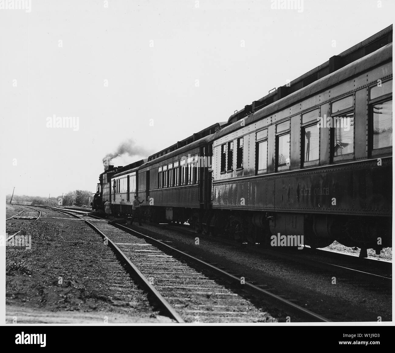 Shelby County, Iowa. Several trains a day stop at the Irwin depot, most of them just long enough to . . .; Scope and content:  Full caption reads as follows: Shelby County, Iowa. Several trains a day stop at the Irwin depot, most of them just long enough to drop the mail. The post mistress generally carries the mail sack herself from the station to the Post Office fifty yards away. Stock Photo