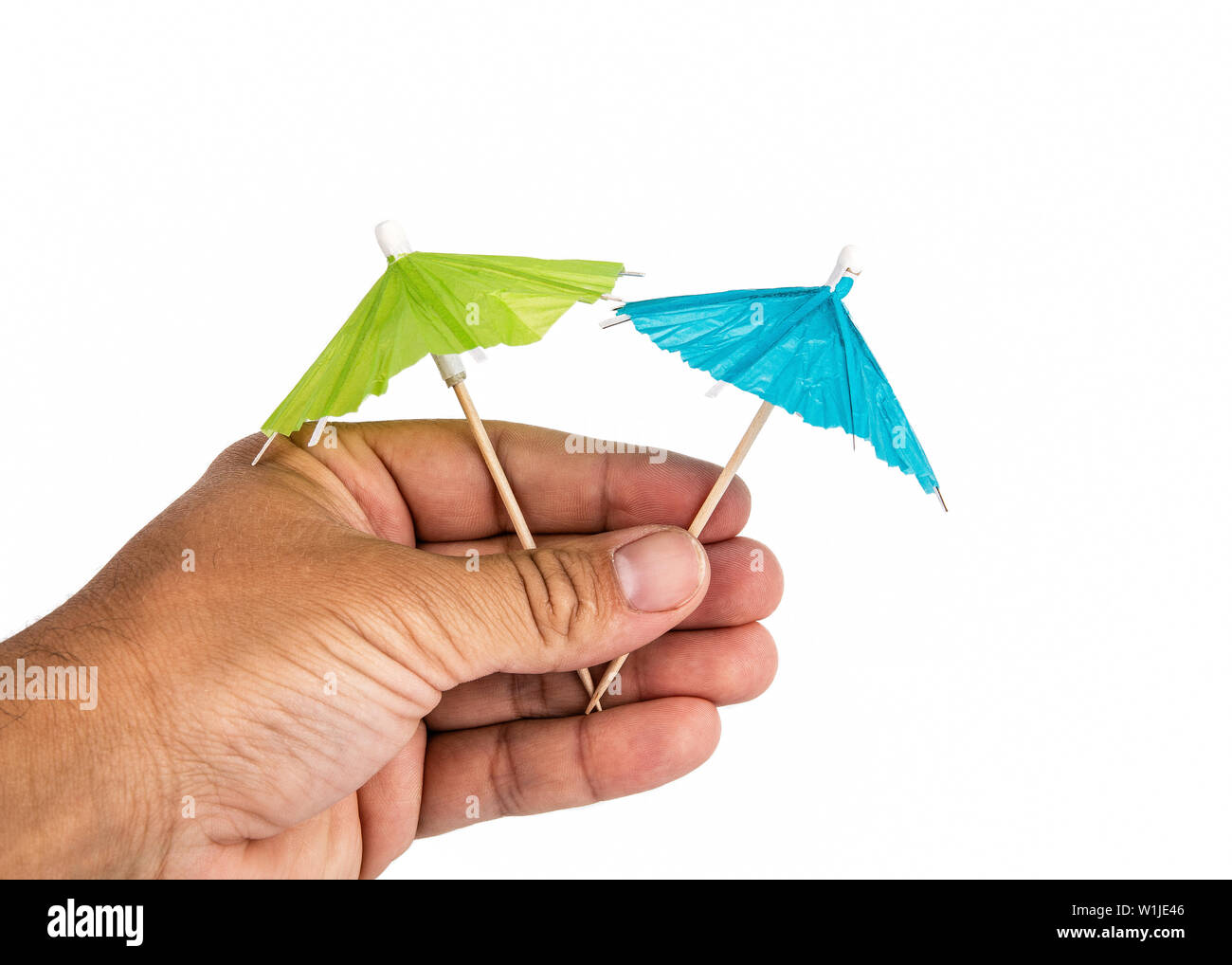 Hand holding cocktail umbrella hi-res stock photography and images - Alamy
