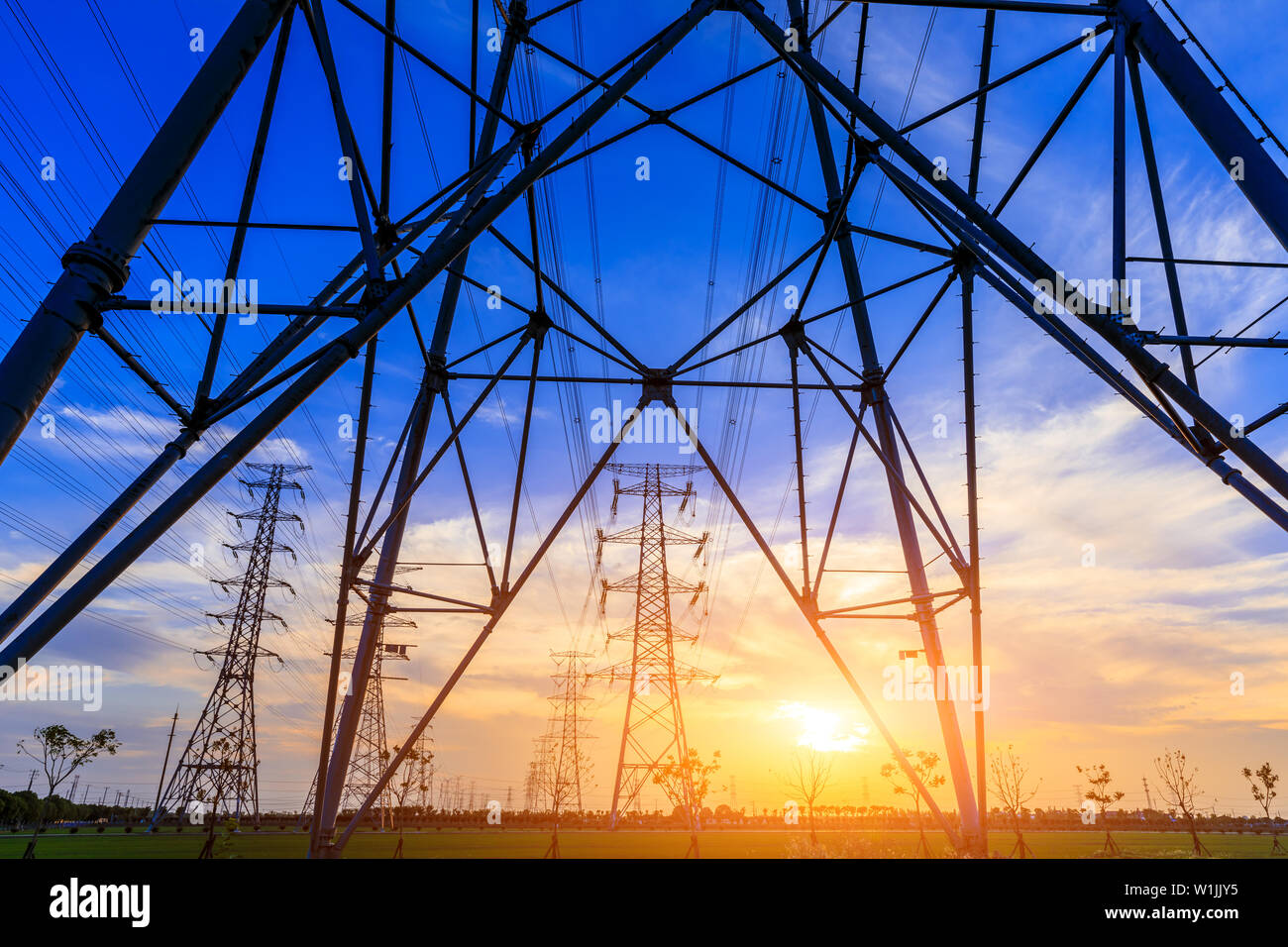 High voltage post,High voltage tower sky sunset background Stock Photo ...