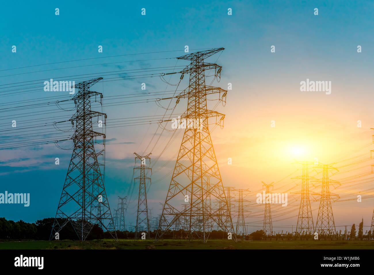 High voltage post,High voltage tower sky sunset background Stock Photo ...