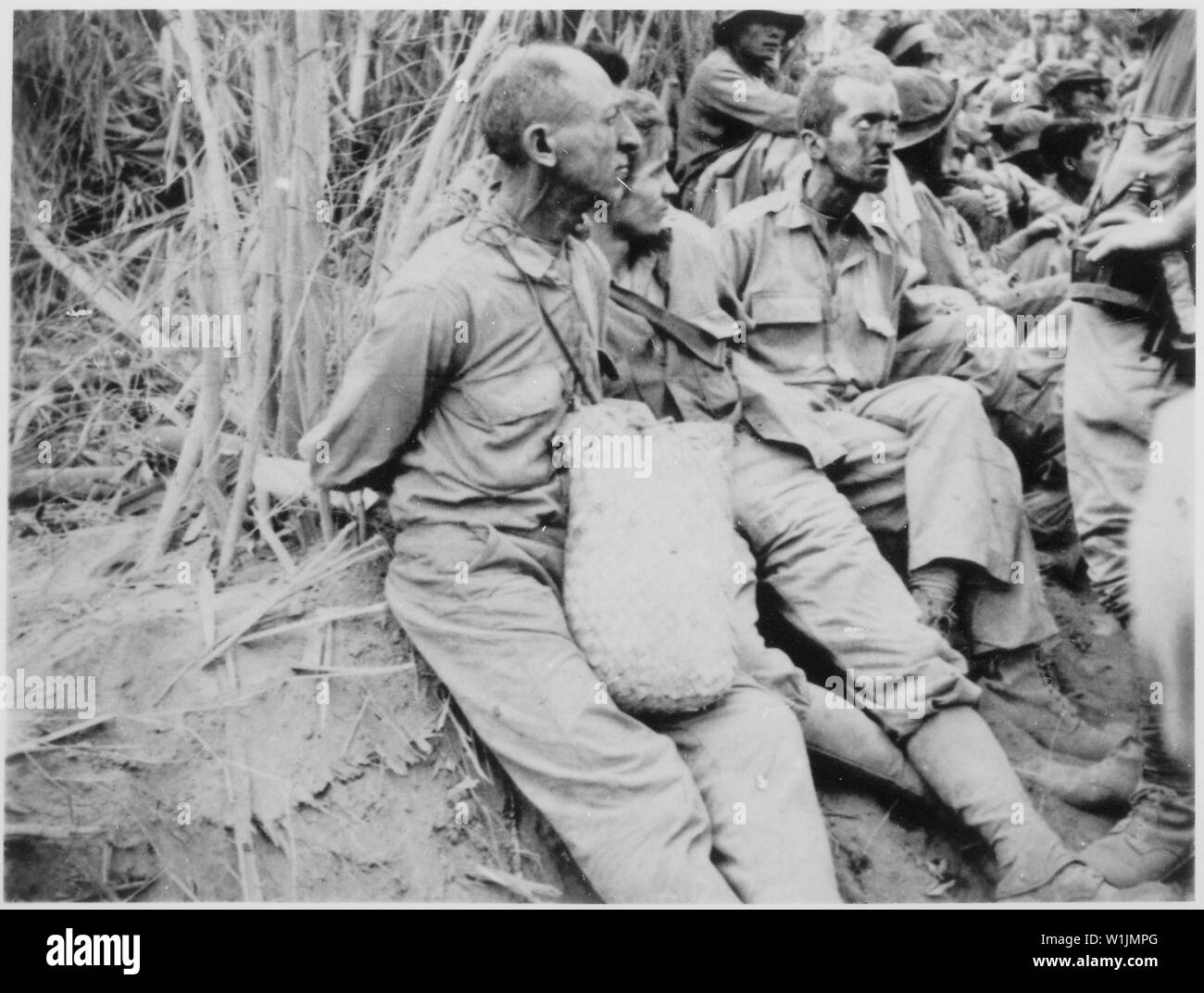 The March of Death. Along the March [on which] these prisoners were photographed, they have their hands tied behind their backs. The March of Death was about May 1942, from Bataan to Cabanatuan, the prison camp.; General notes:  Use War and Conflict Number 1144 when ordering a reproduction or requesting information about this image. Stock Photo