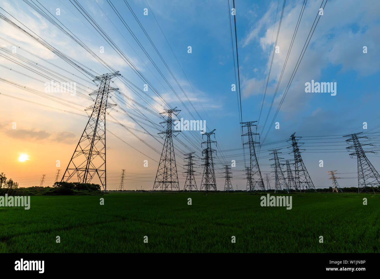 High voltage post,High voltage tower sky sunset background Stock Photo ...
