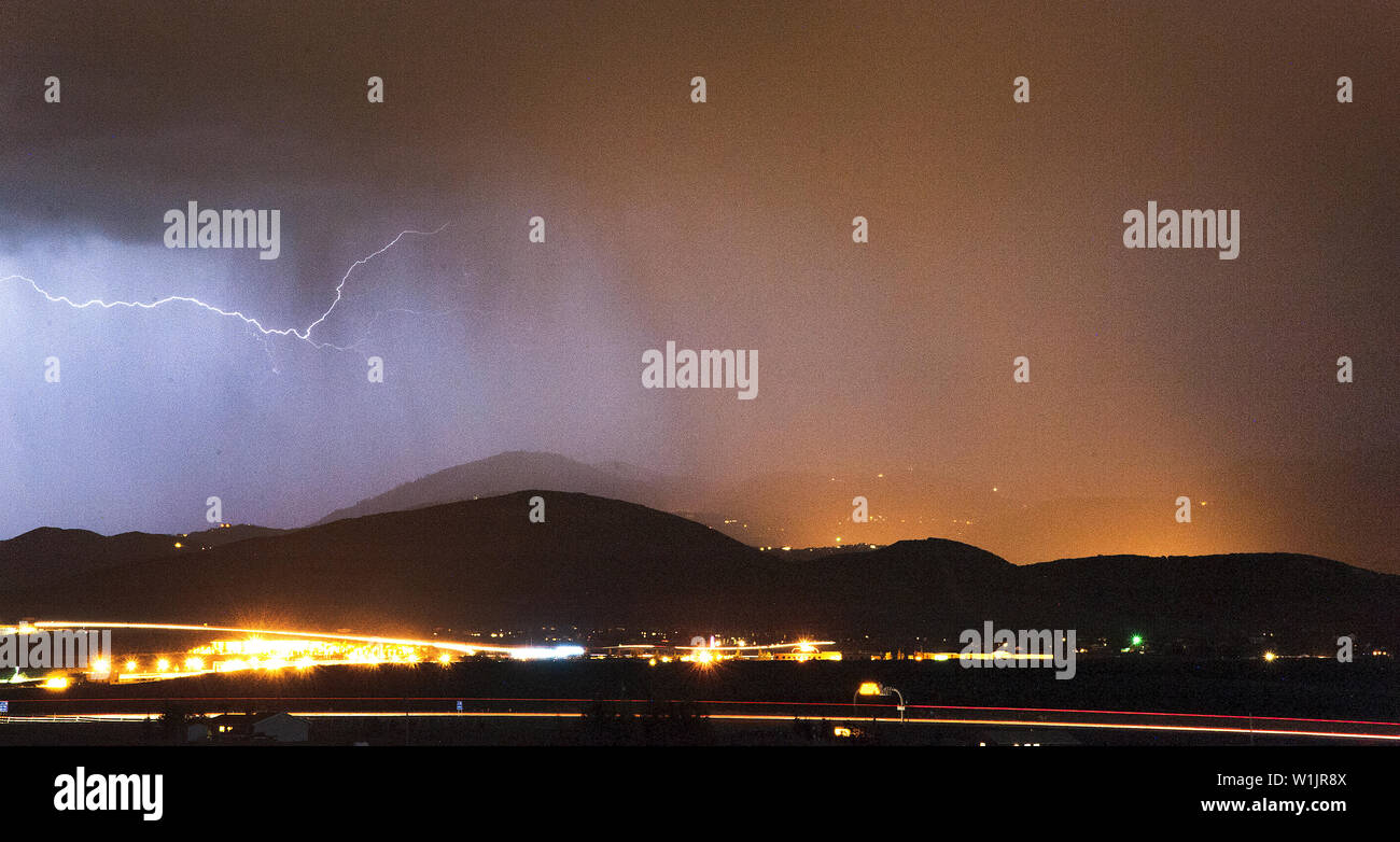 A thunderbolt stretches across the sky high above Park City, Utah during a night time thunderstorm. (c) 2014 Stock Photo