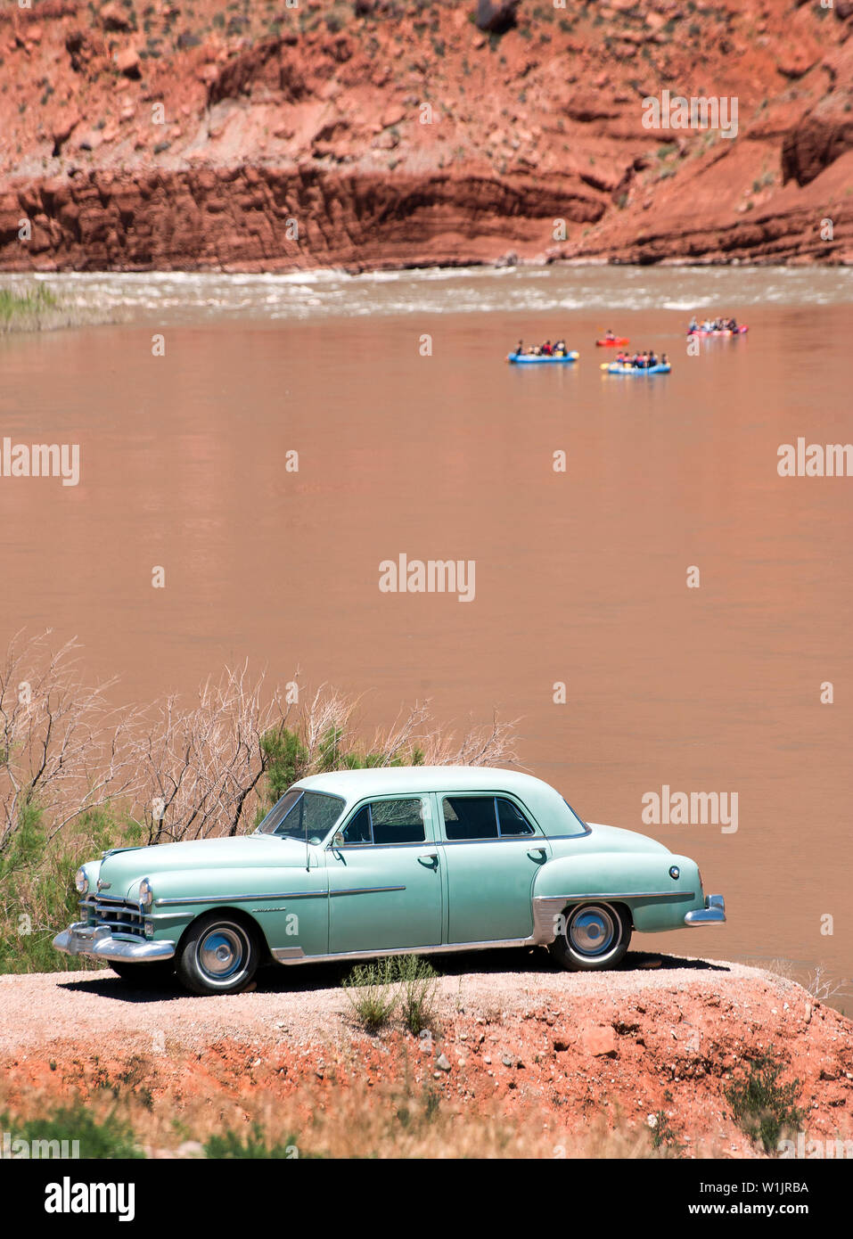 A beautifully-restored old car sits proudly on a perch high above the Colorado River at the Castle Creek Winery near Red Cliffs Lodge east of Moab, Ut Stock Photo