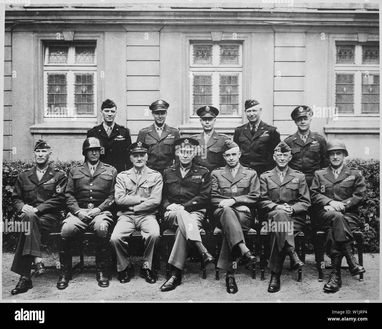 This is the brass that did it. Seated are Simpson, Patton (as if you didn't know), Spaatz, Ike himself, Bradley, Hodges and Gerow. Standing are Stearley, Vandenberg, Smith, Weyland and Nugent., ca. 1945; General notes:  Use War and Conflict Number 751 when ordering a reproduction or requesting information about this image. Stock Photo