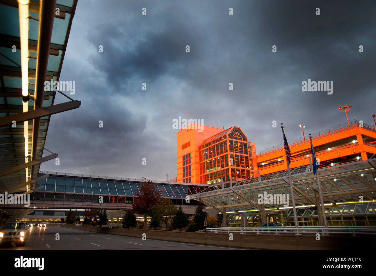The brilliant orange setting sun reflects off a parking garage at the