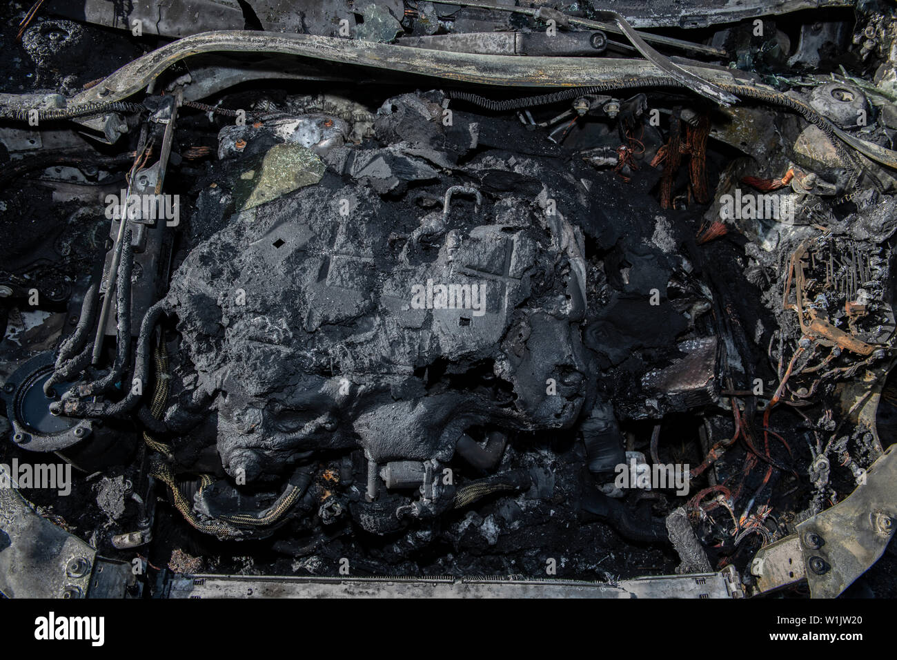 Berlin, Germany. 03rd July, 2019. The engine block of a car in the Hansaviertel on Bartningallee has burnt out. A total of five cars were set on fire there during the night. The police are assuming arson. Last night, six vehicles were already on fire in Berlin. Credit: Paul Zinken/dpa/Alamy Live News Stock Photo