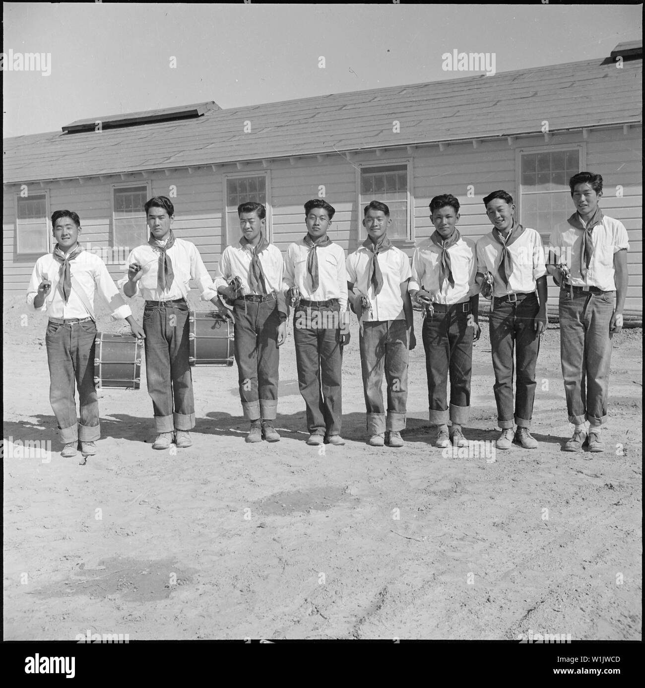 Topaz, Utah. Members of the drum and bugle corp, formerly a boy scout troop at Los Angeles, pose fo . . .; Scope and content:  The full caption for this photograph reads: Topaz, Utah. Members of the drum and bugle corp, formerly a boy scout troop at Los Angeles, pose for their photograph at the Topaz Relocation Center. Stock Photo