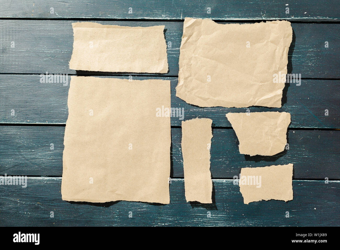 ripped pieces of old paper on black wooden background Stock Photo - Alamy