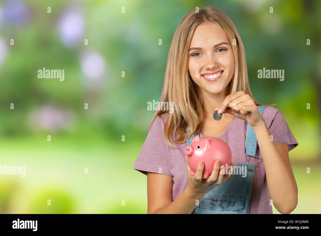 picture of lovely woman with piggy bank Stock Photo - Alamy