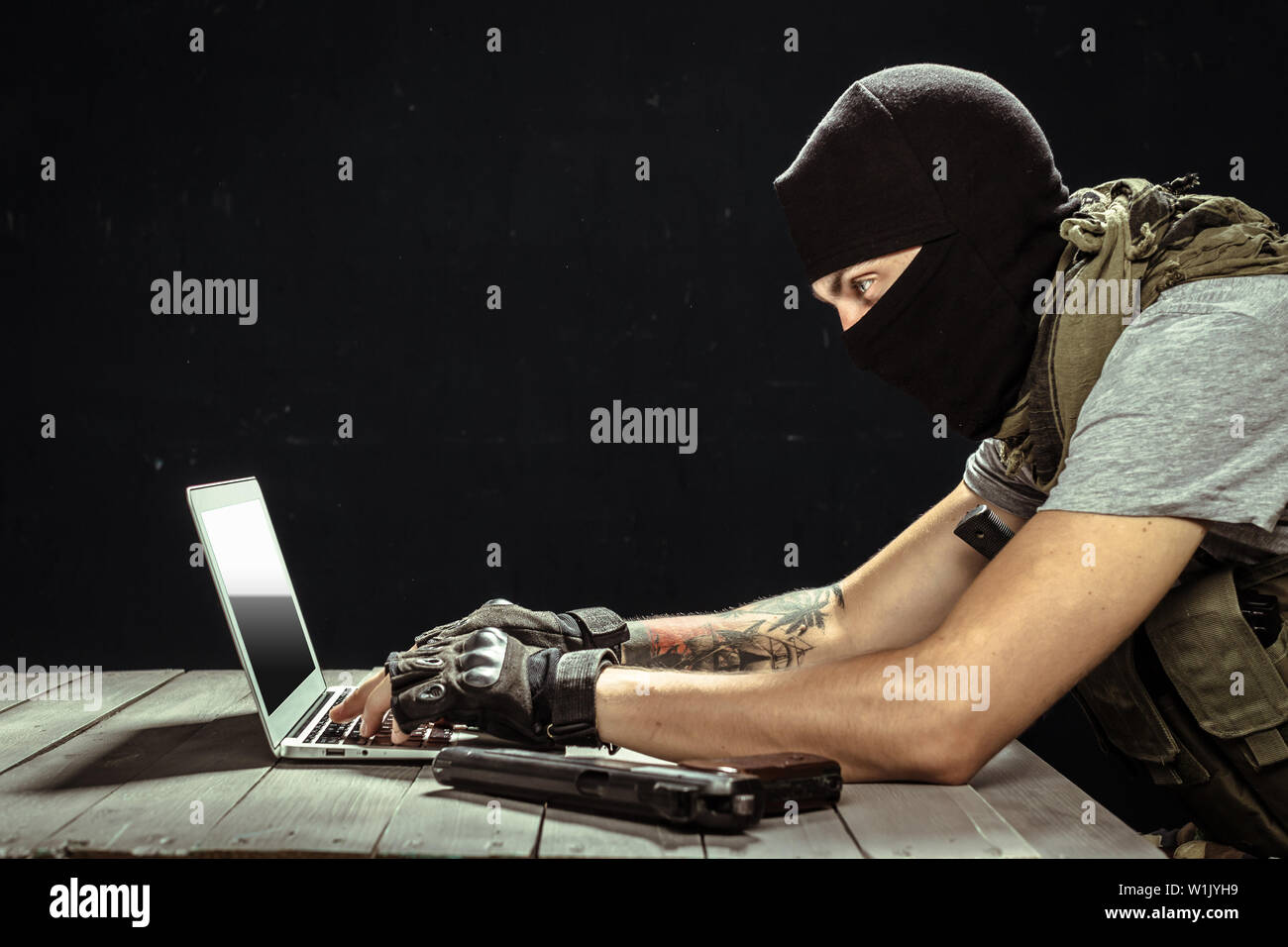 Terrorist working on his computer Stock Photo - Alamy