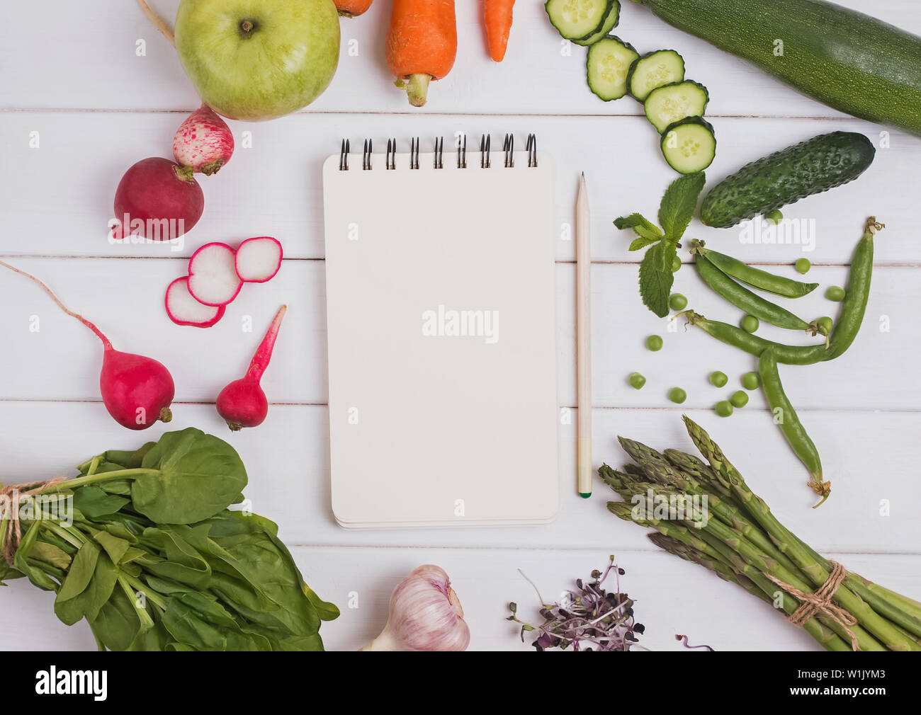 Meal plan of menu concept. Empty paper mock-up in the cener of different vegetables and fruits, top view Stock Photo