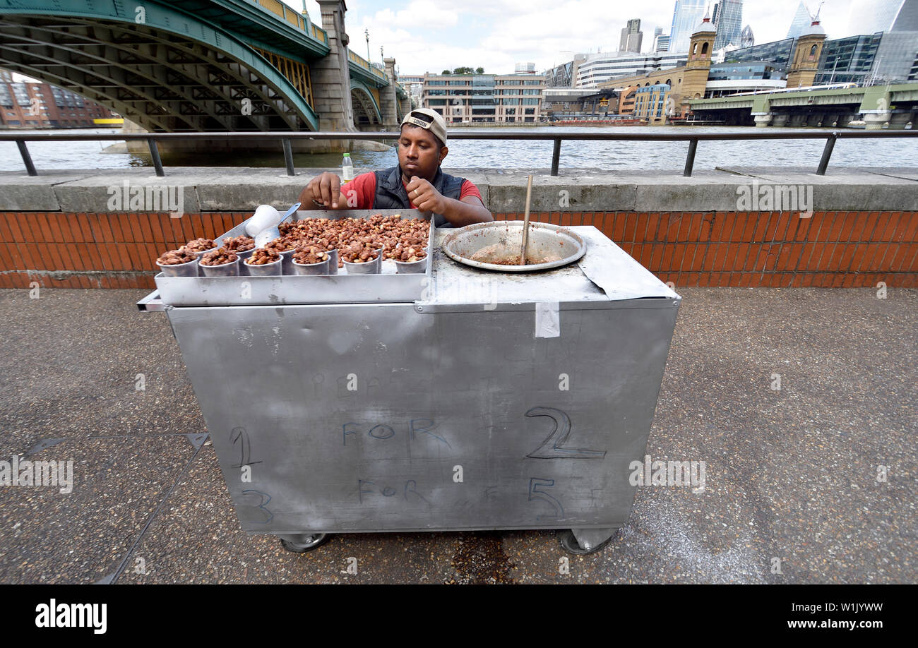 London, England, UK. Man selling caramelized nuts on the South Bank