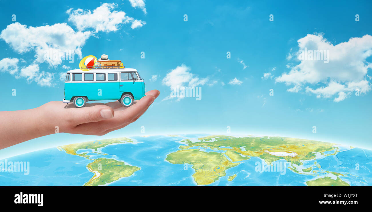 Travel around the world concept. Old blue van with luggage in hand. Globe and sky in background. Free space beside fot text. Stock Photo