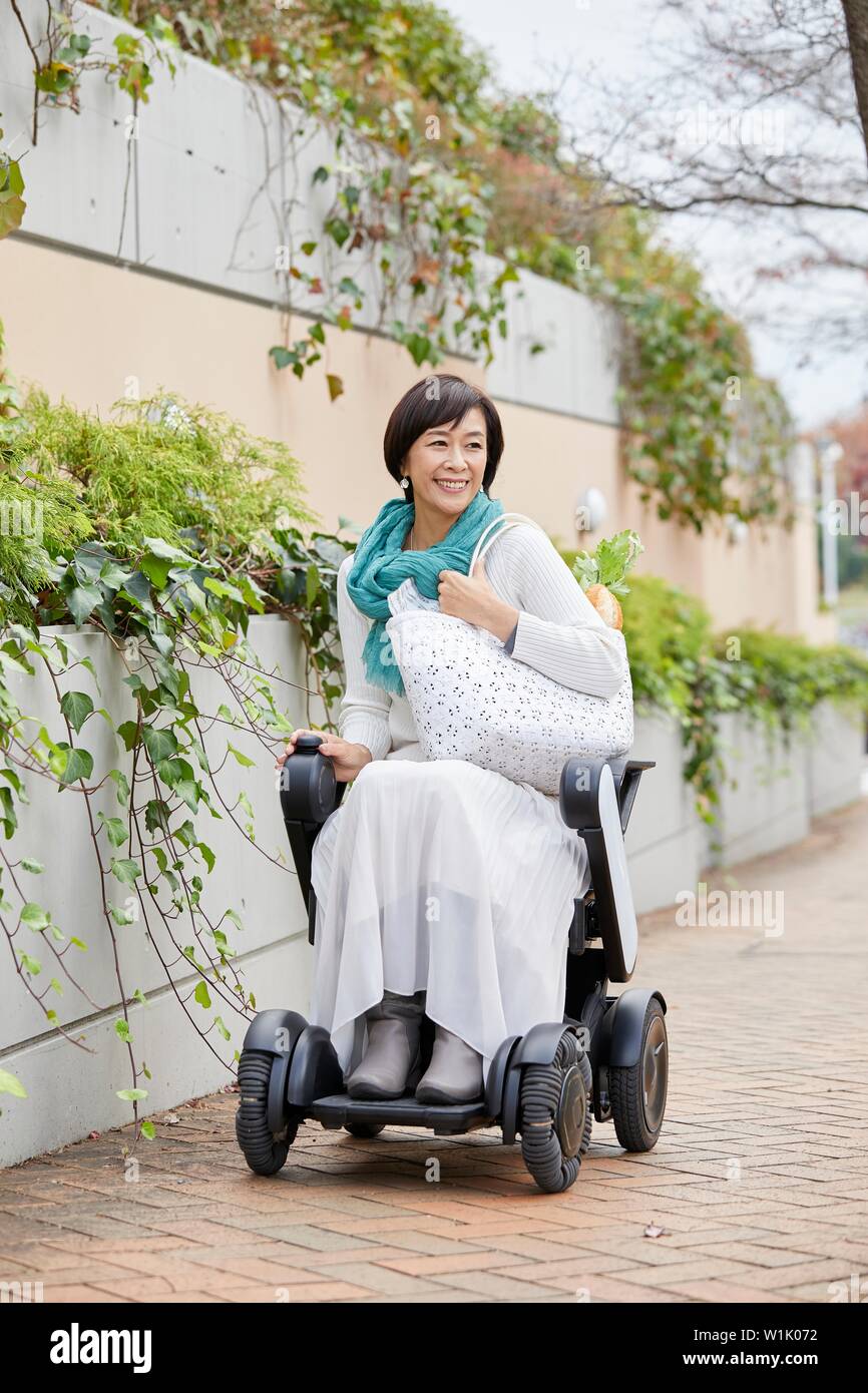 Japanese senior woman on electric wheelchair Stock Photo Alamy