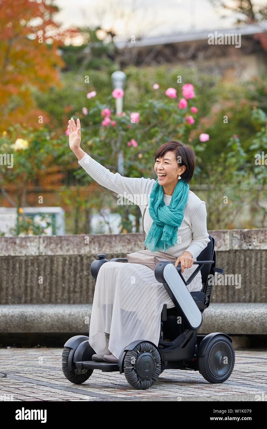 Japanese senior woman on electric wheelchair Stock Photo Alamy