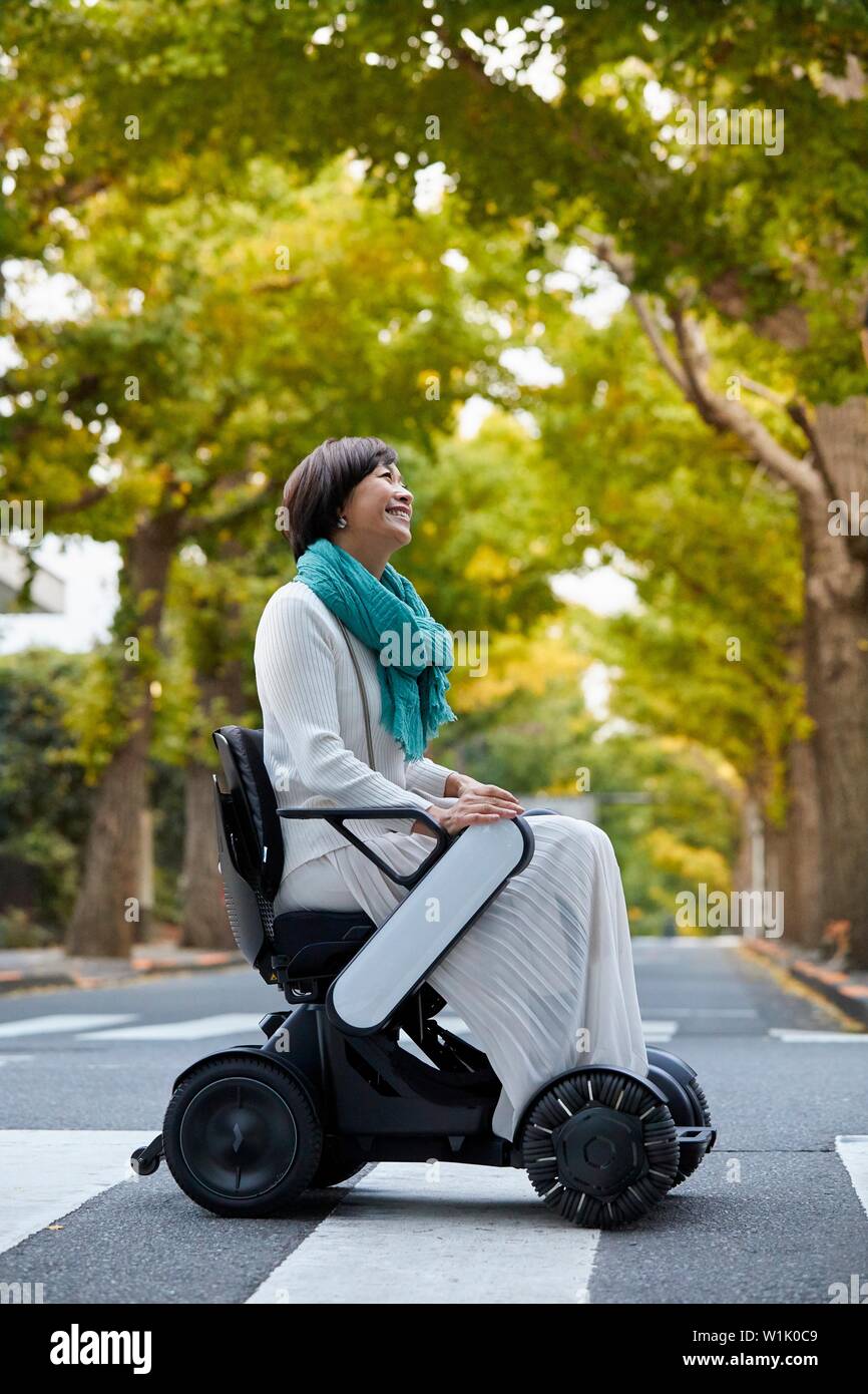 Japanese senior woman on electric wheelchair Stock Photo Alamy
