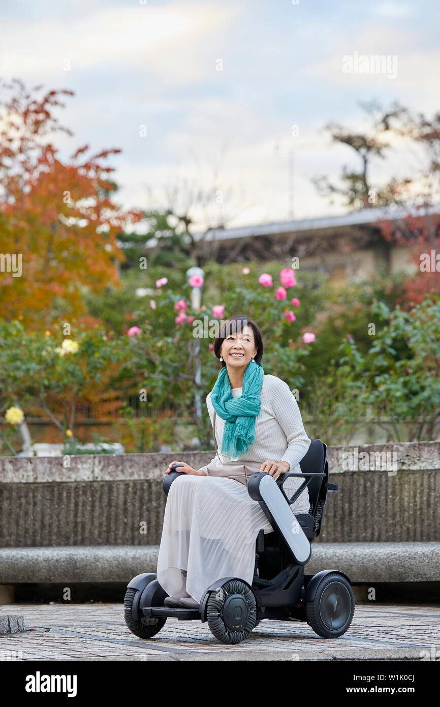 Japanese senior woman on electric wheelchair Stock Photo Alamy