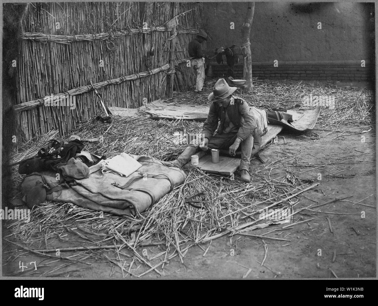 Typical sleeping quarters of an officer in China. Photo of Lieutenant (now Captain) Stamford after the battle of Yang Sing., ca. 1900; General notes:  Use War and Conflict Number 329 when ordering a reproduction or requesting information about this image. Stock Photo