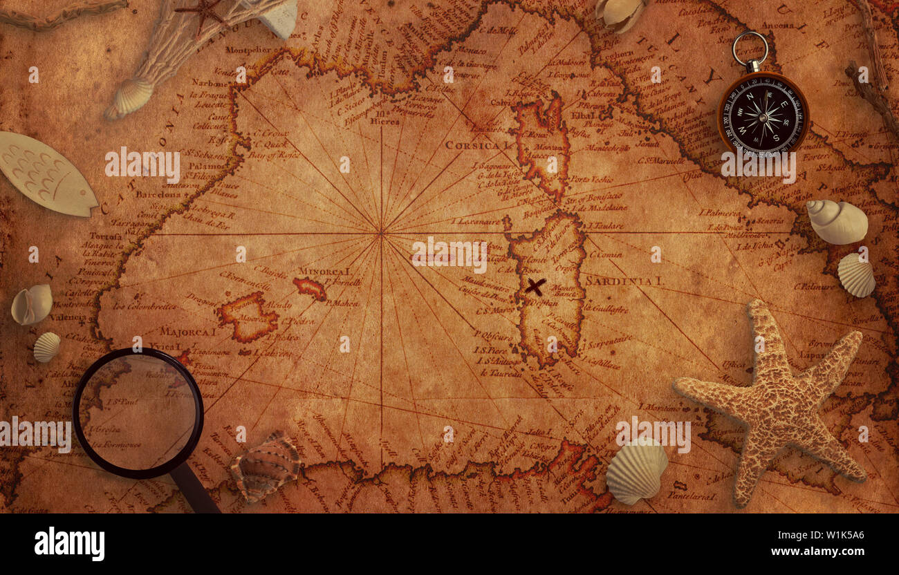 Old treasure map concept. Magnifier, compass and sea decorations on the map. Top view. Stock Photo