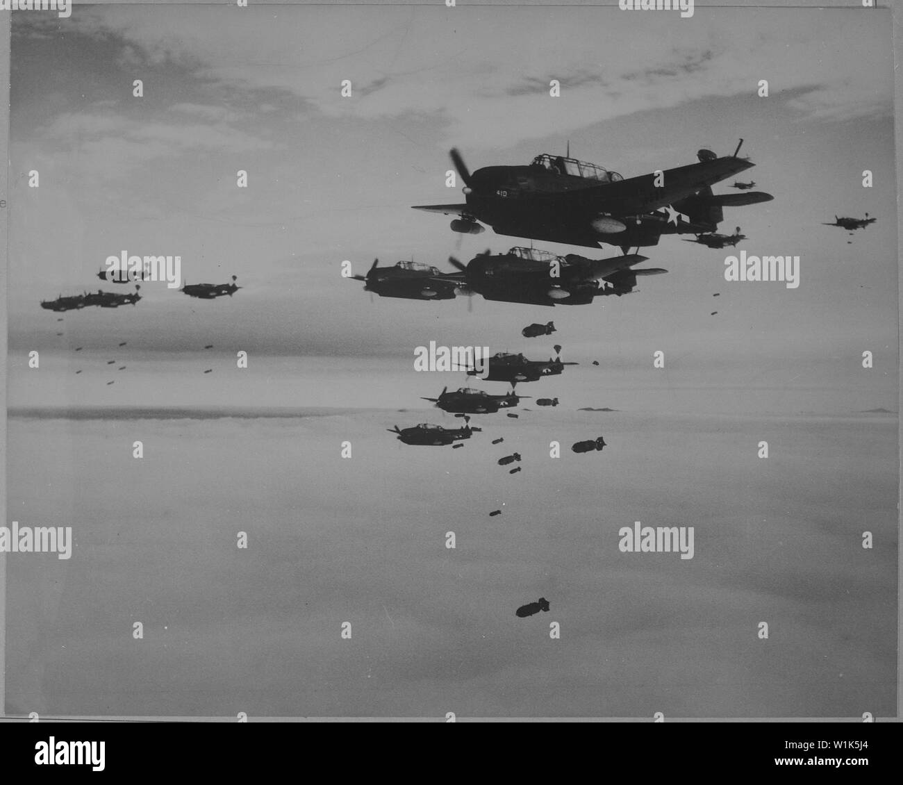 USS ESSEX based TBMs and SB2Cs dropping bombs on Hakodate, Japan.; General notes:  Use War and Conflict Number 1238 when ordering a reproduction or requesting information about this image. Stock Photo