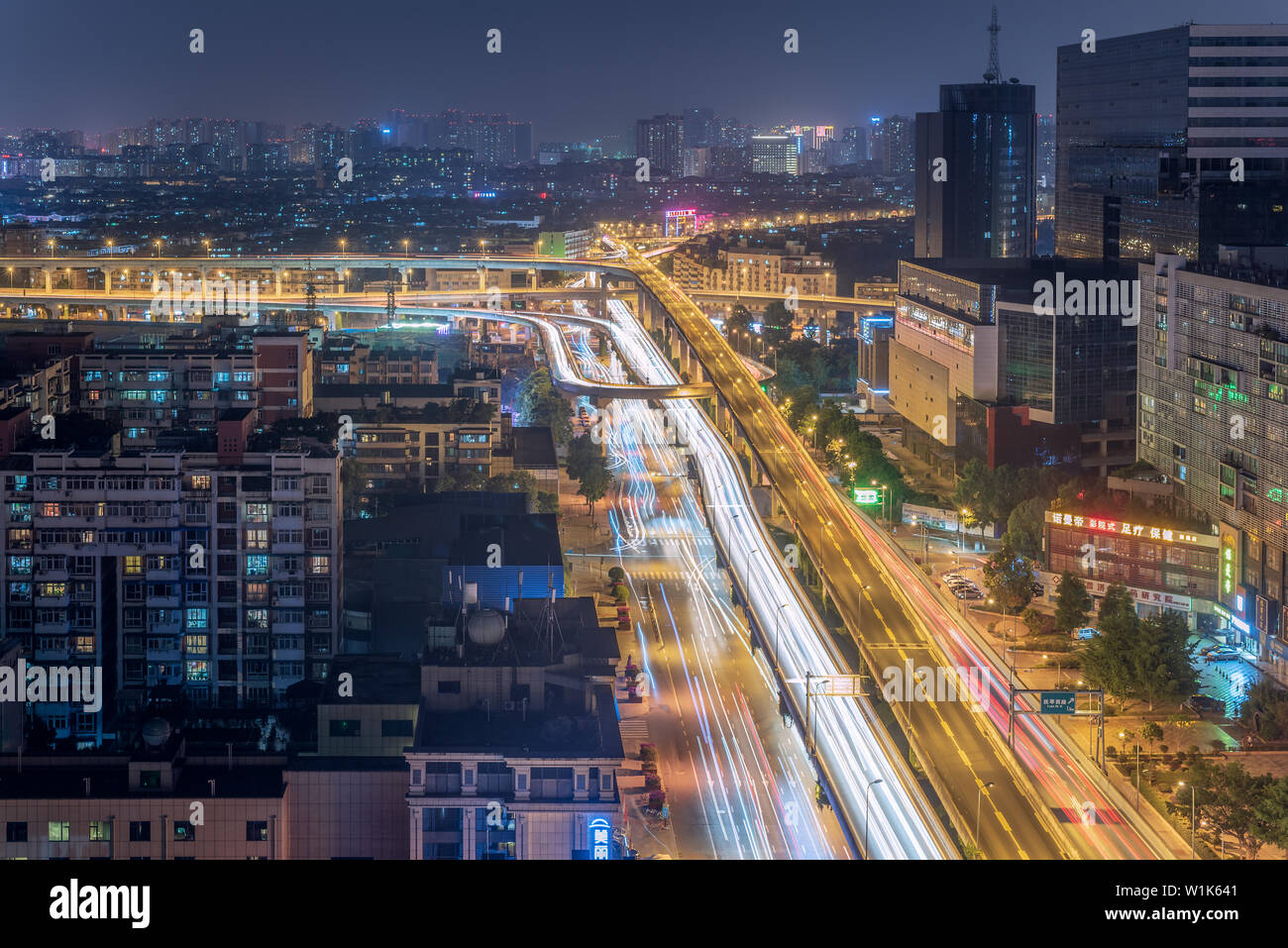 Chengdu, Sichuan province, China - June 3, 2019 : Busy car traffic on ChengWenLiJiao interchange aerial view at night in QingYangQu district Stock Photo