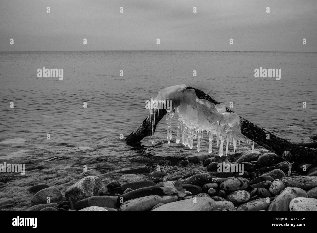 The icicles are a dead giveaway that this in not a balmy day at the beach.  It's beautiful, but not so warm. Stock Photo