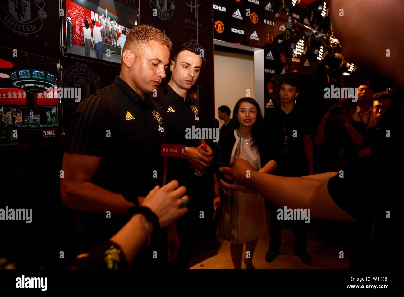 English football player Wes Brown, left, and Bulgarian football player Dimitar Berbatov attend a promotional event at the first club-themed entertainment and experience center launched by Manchester United in Beijing, China, 3 July 2019. Stock Photo