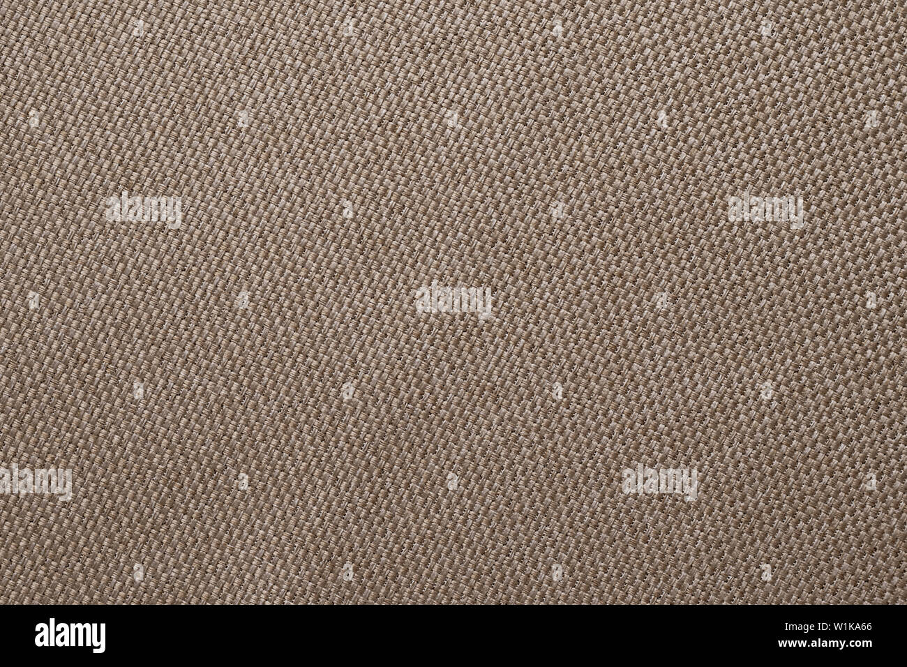 Brown fabric texture of sackcloth. Clothing background. Cloth backdrop. Pattern of sacking, bagging. Linen fabric surface close-up. Stock Photo