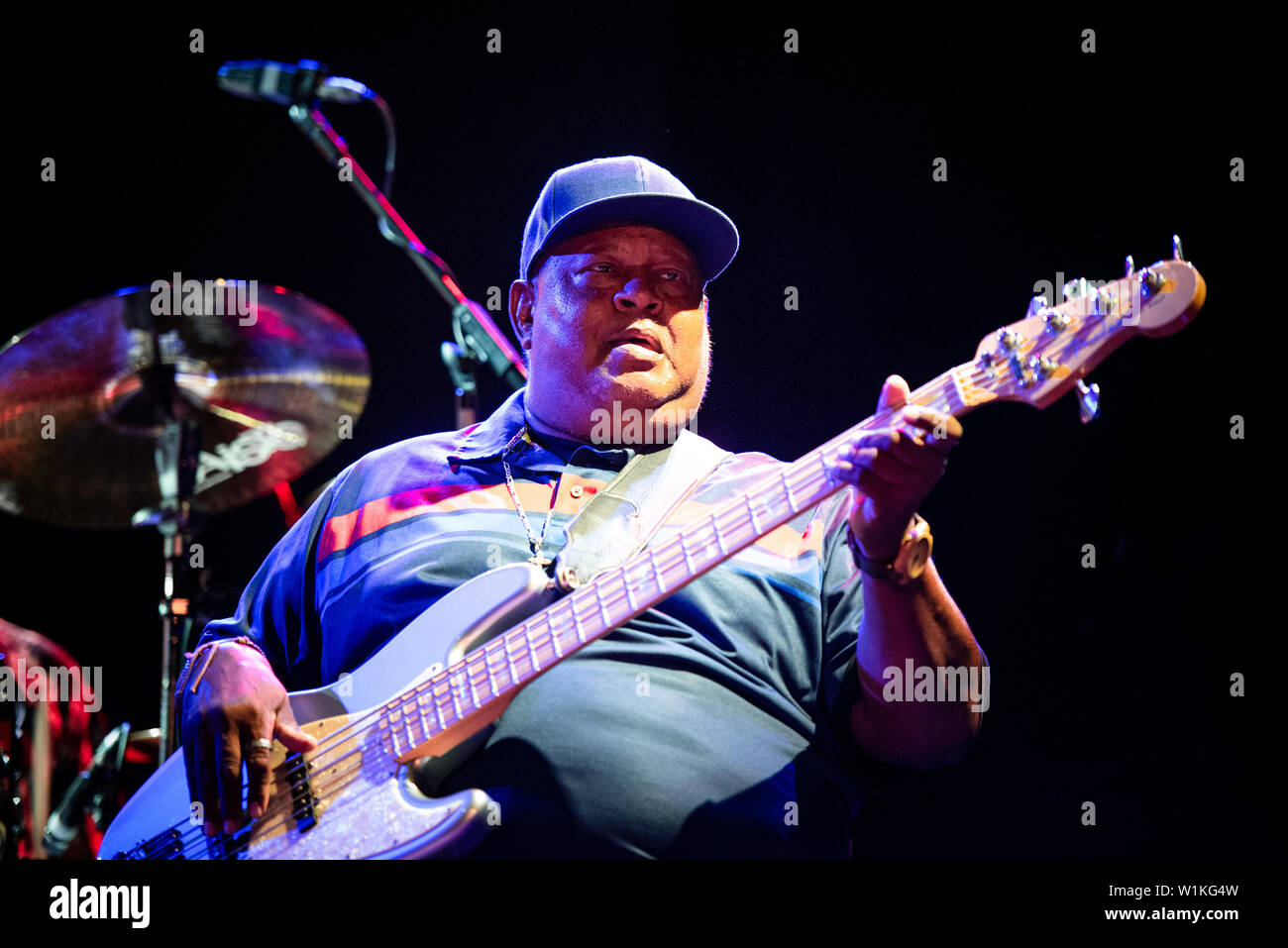 Juan Nelson, bassist of the Innocent Criminals, performing live on stage together with Ben Harper at the Gruvillage Festival in Grugliasco, near Turin Stock Photo