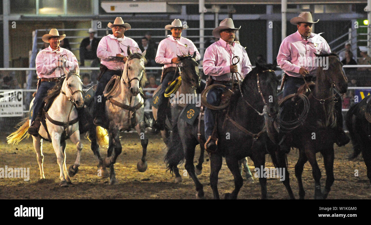 Clad in pink, the Weber County Sheriff's Posse rides into the rodeo