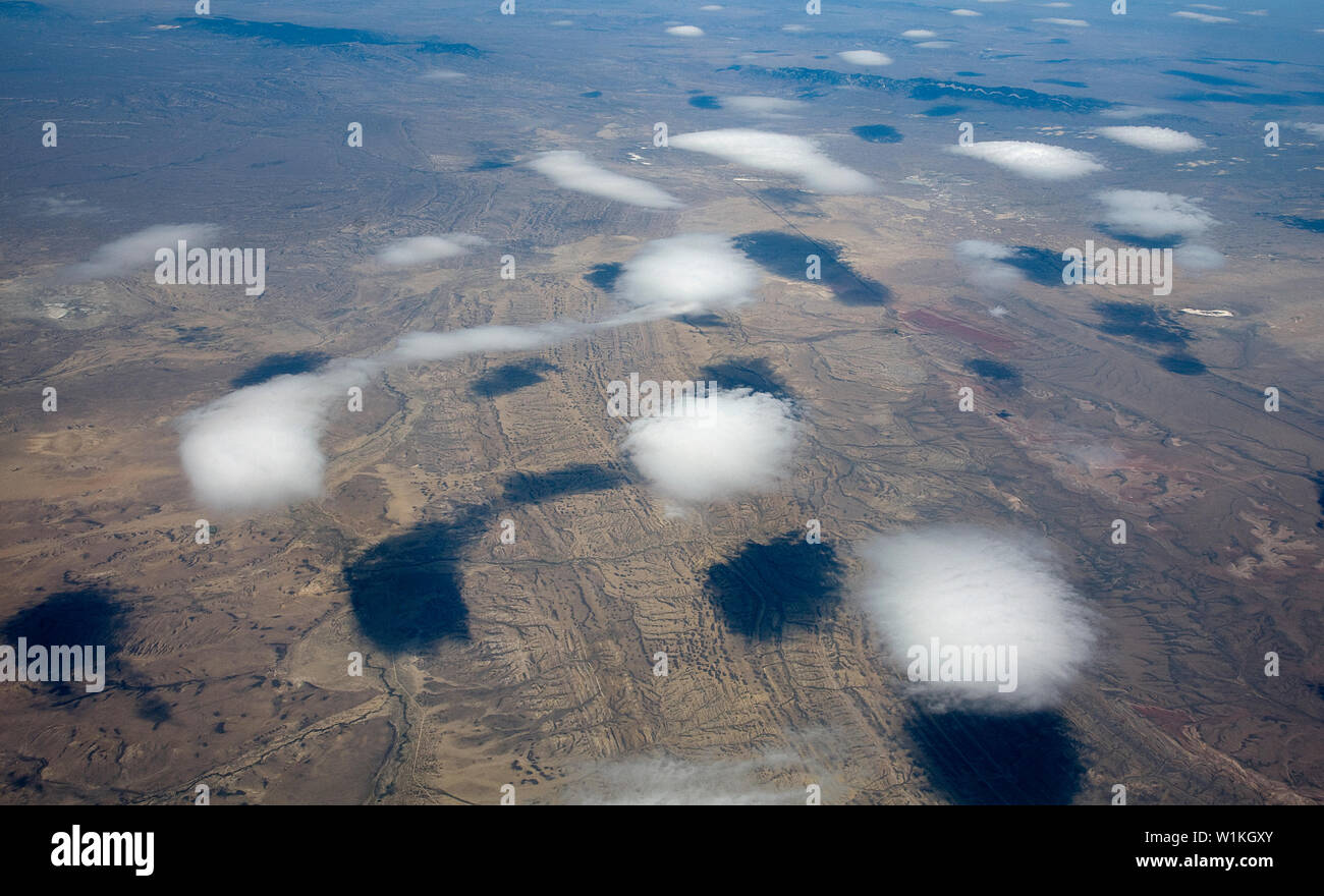 Puffy clouds paint shadows on the western desert landscape north of Rawlins, Wyoming. (c) 2009 Tom Kelly Stock Photo