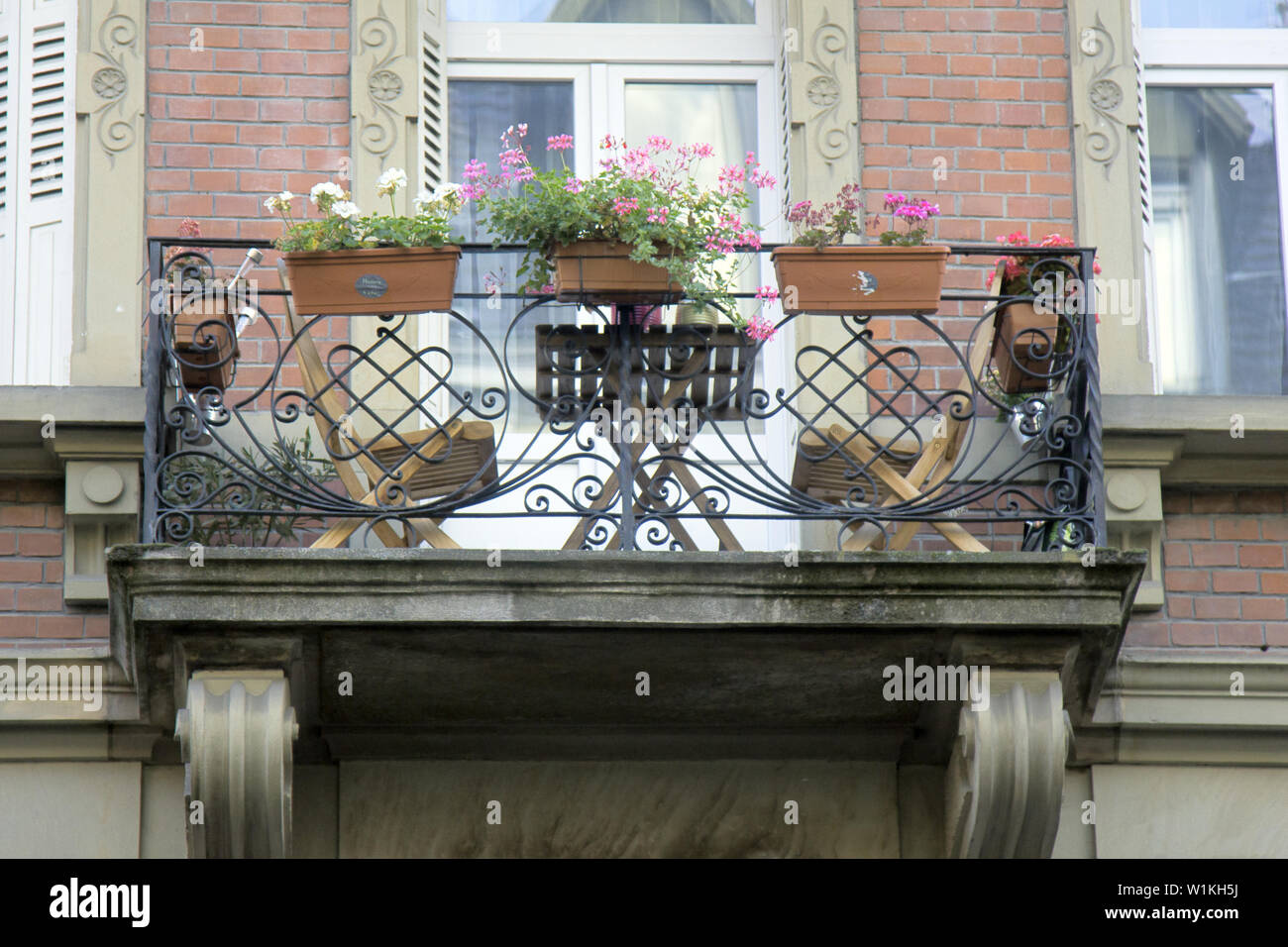 Cozy balcony with sun loungers and flower vases, balcony of the house Stock  Photo - Alamy