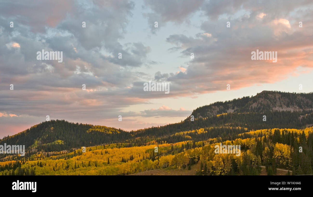 The sunset sky hangs over bright fall colors in Guardsman Pass high above Park City, Utah. Stock Photo