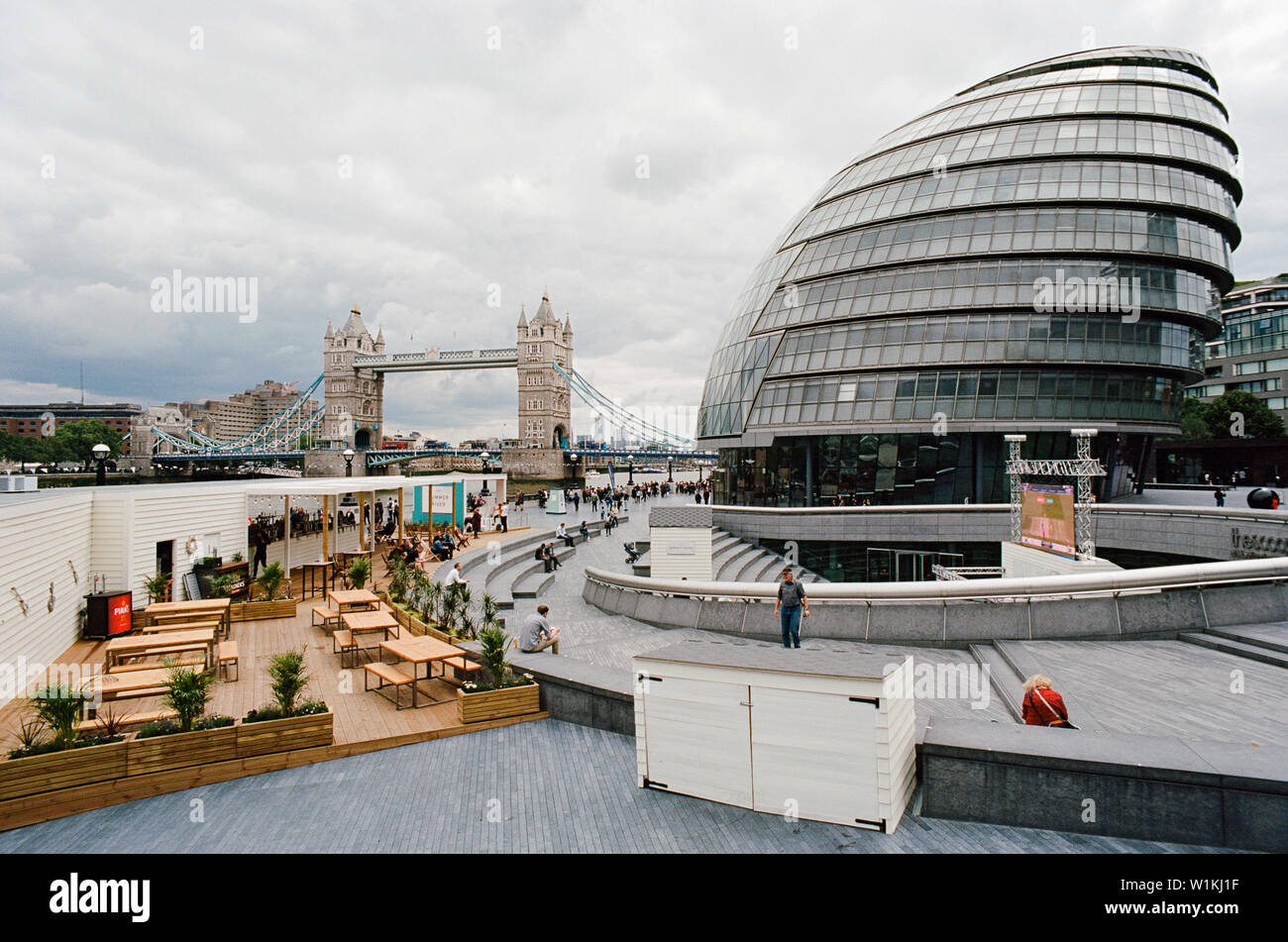 City Hall and Tower Bridge, London UK, on the South Bank of the River Thames, with The Scoop outdoor amphitheatre in foreground Stock Photo